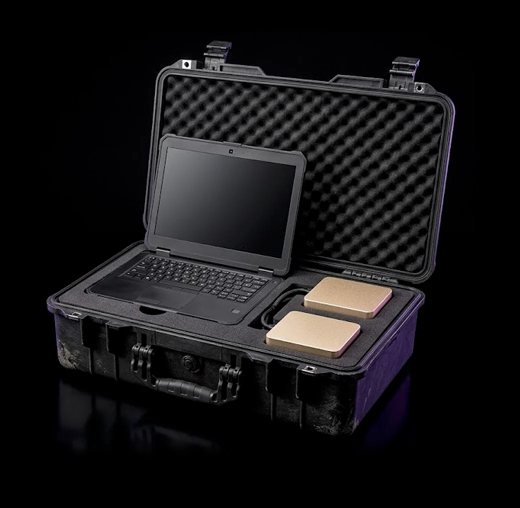 Product render of the RAPTOR unit: a ruggedised transit case, lid open, holding a console and two compute nodes seated in cut foam